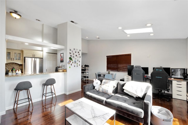 living room featuring vaulted ceiling and dark hardwood / wood-style flooring