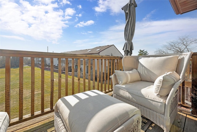 wooden terrace featuring a yard