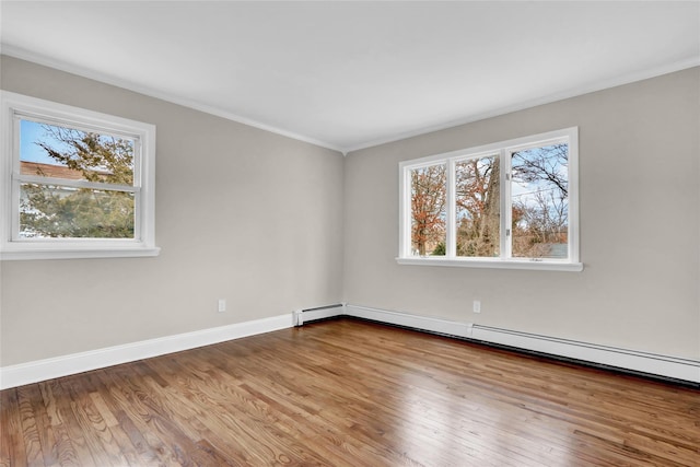 unfurnished room with wood-type flooring, a baseboard radiator, and ornamental molding