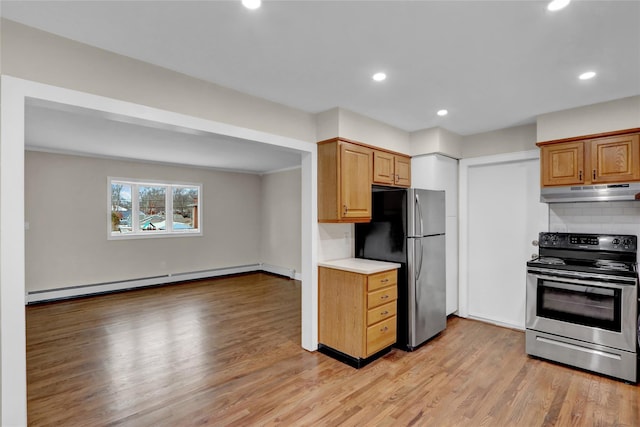 kitchen featuring stainless steel appliances, a baseboard heating unit, light hardwood / wood-style floors, and decorative backsplash