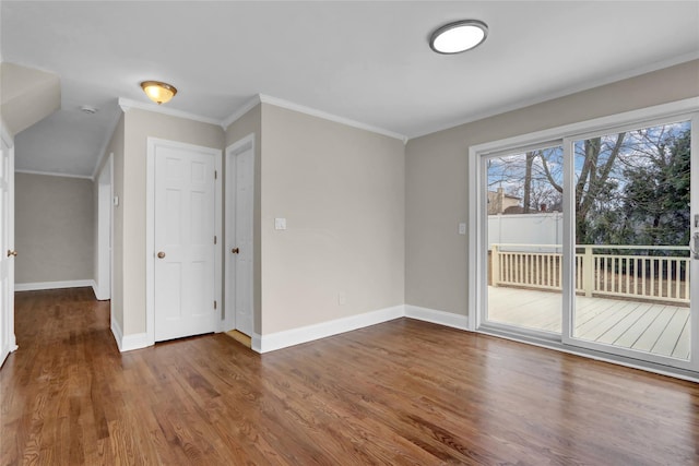 empty room with crown molding and dark hardwood / wood-style flooring