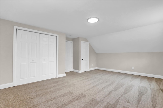 additional living space featuring carpet floors and vaulted ceiling