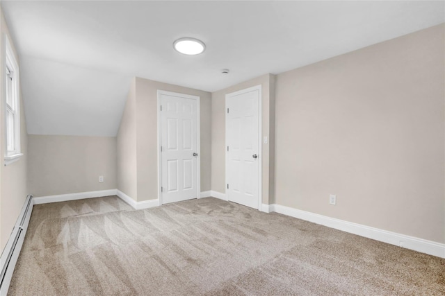 bonus room featuring baseboard heating, light colored carpet, and vaulted ceiling