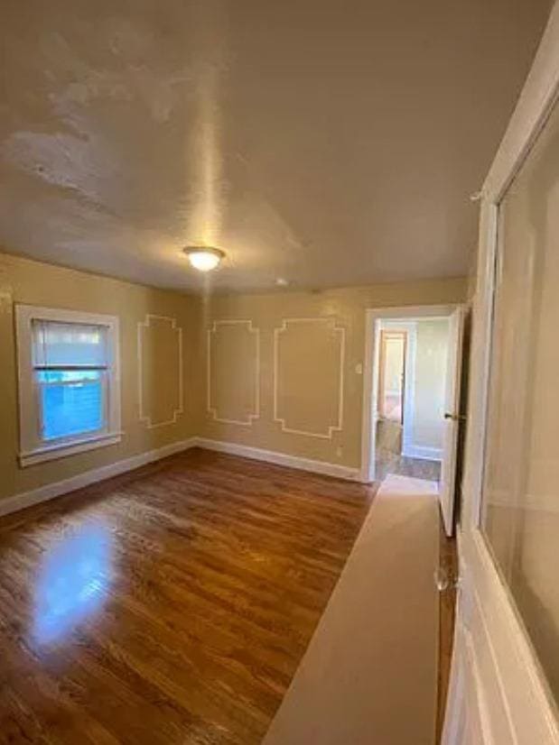 unfurnished room with hardwood / wood-style floors