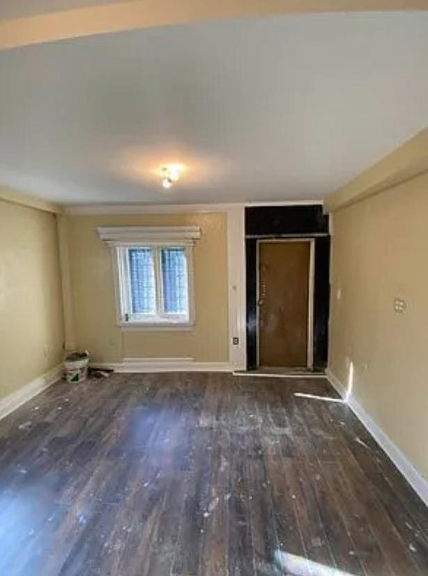 empty room featuring dark hardwood / wood-style flooring