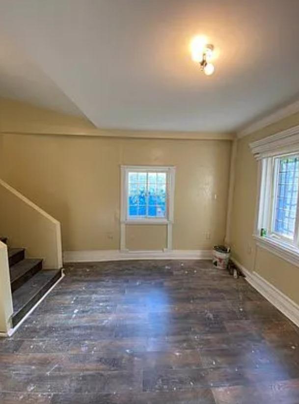 spare room featuring dark hardwood / wood-style flooring and ornamental molding