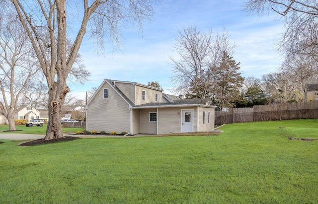 back of house with a yard