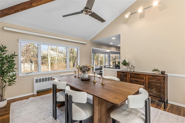 dining area with ceiling fan, dark wood-type flooring, radiator heating unit, and high vaulted ceiling