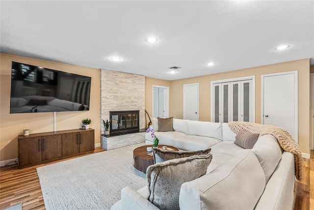 living room with a fireplace and light hardwood / wood-style flooring