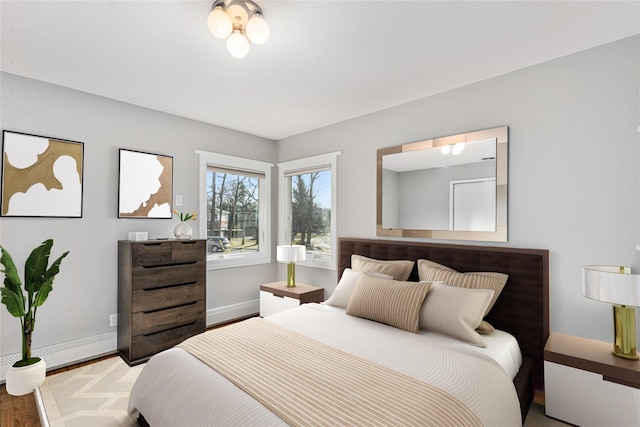 bedroom featuring hardwood / wood-style flooring and baseboard heating