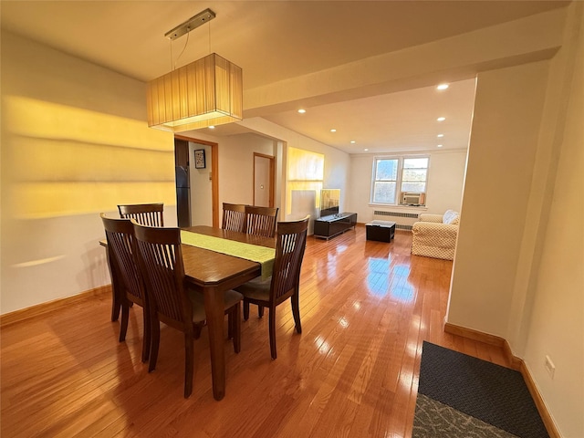 dining room with radiator and hardwood / wood-style flooring