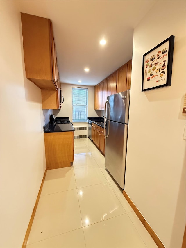 kitchen featuring light tile patterned floors, sink, and stainless steel appliances