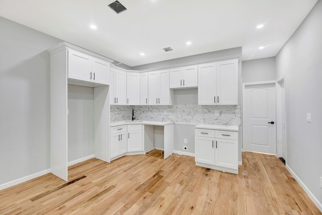 kitchen featuring white cabinetry and tasteful backsplash