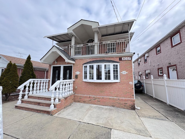 back of property with a balcony