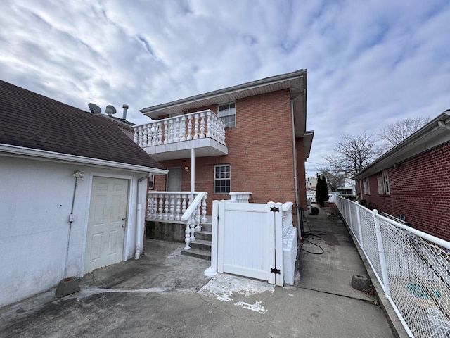 rear view of house featuring a balcony