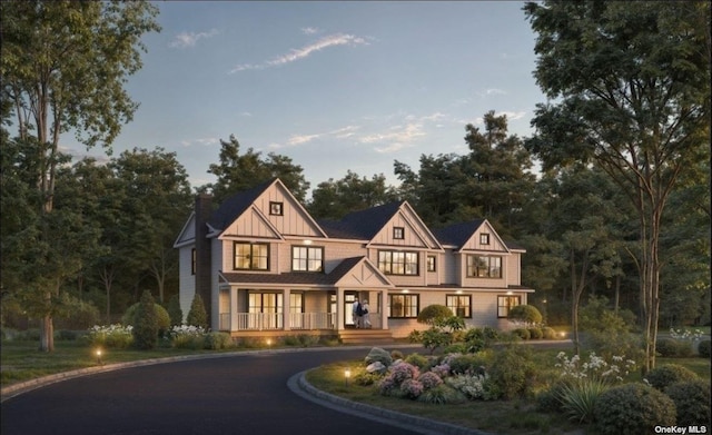 tudor home featuring covered porch