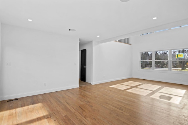 spare room with light hardwood / wood-style flooring