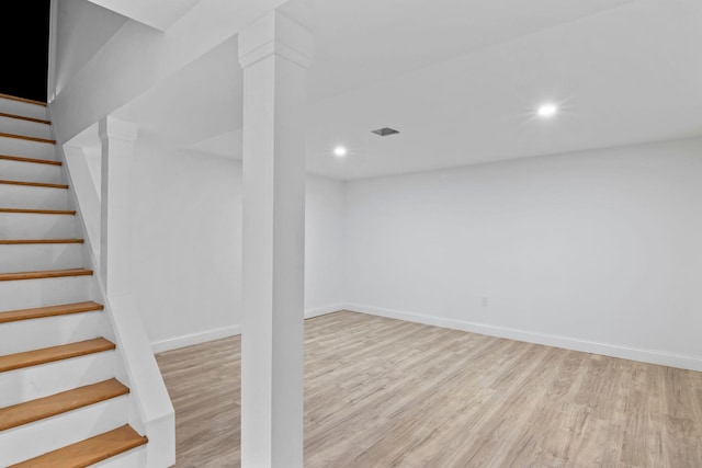 basement with light hardwood / wood-style flooring