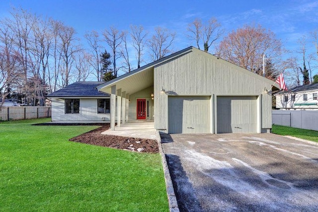 ranch-style house featuring a garage and a front lawn