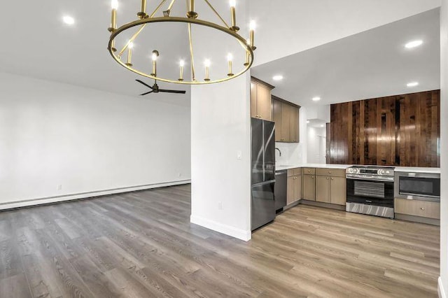 kitchen featuring a baseboard radiator, appliances with stainless steel finishes, dark hardwood / wood-style floors, and pendant lighting