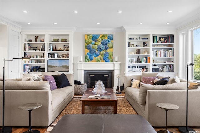 living room featuring crown molding and built in features