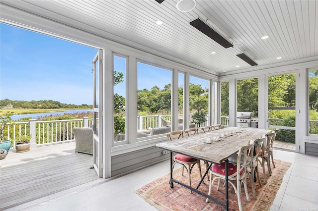 sunroom / solarium with a water view and wooden ceiling