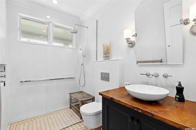 bathroom featuring ornamental molding, vanity, toilet, and a shower