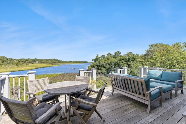 deck with a water view and an outdoor hangout area