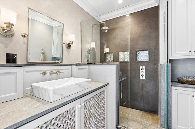 bathroom with ornamental molding, vanity, and a shower