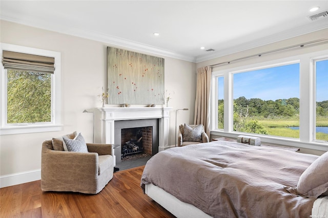 bedroom featuring ornamental molding and dark hardwood / wood-style flooring