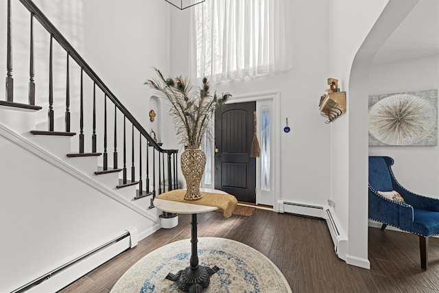 foyer featuring hardwood / wood-style floors and a baseboard heating unit