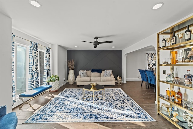 living room featuring a healthy amount of sunlight and ceiling fan