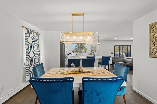 dining area featuring a baseboard radiator and dark hardwood / wood-style flooring