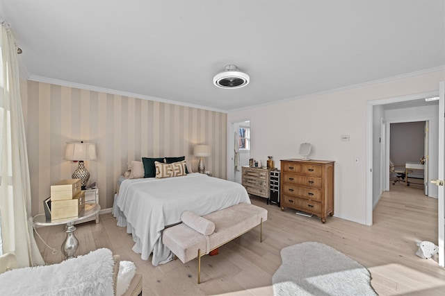 bedroom featuring ornamental molding and light hardwood / wood-style flooring