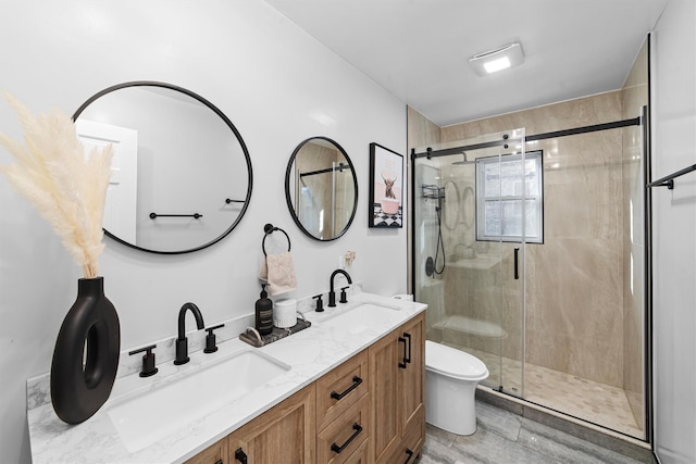 bathroom featuring toilet, vanity, and a shower with shower door