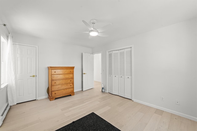 bedroom with a baseboard radiator, light hardwood / wood-style flooring, ceiling fan, and a closet