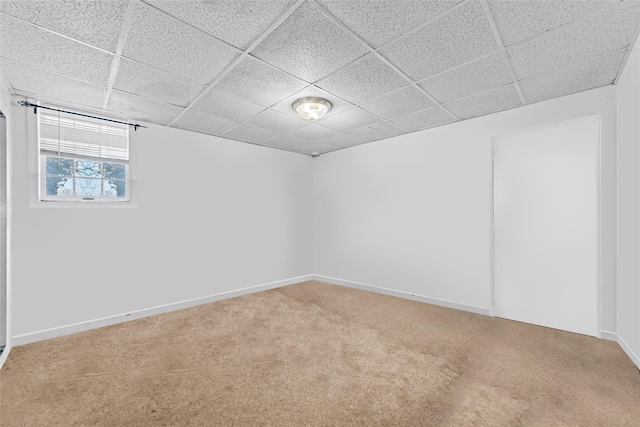 unfurnished room with carpet flooring and a drop ceiling