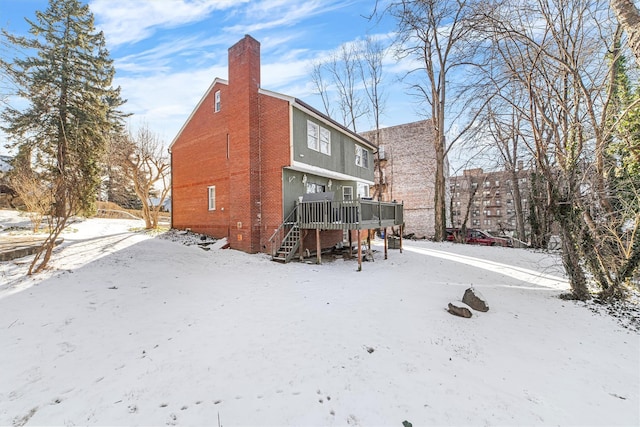 snow covered property featuring a wooden deck