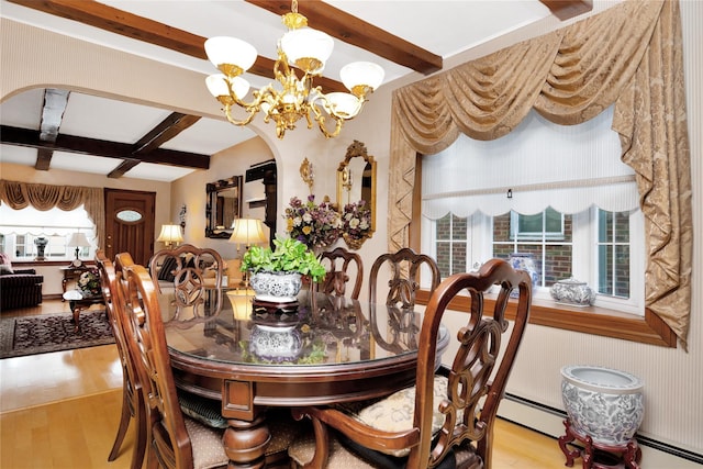 dining area featuring light wood-type flooring, beamed ceiling, and an inviting chandelier