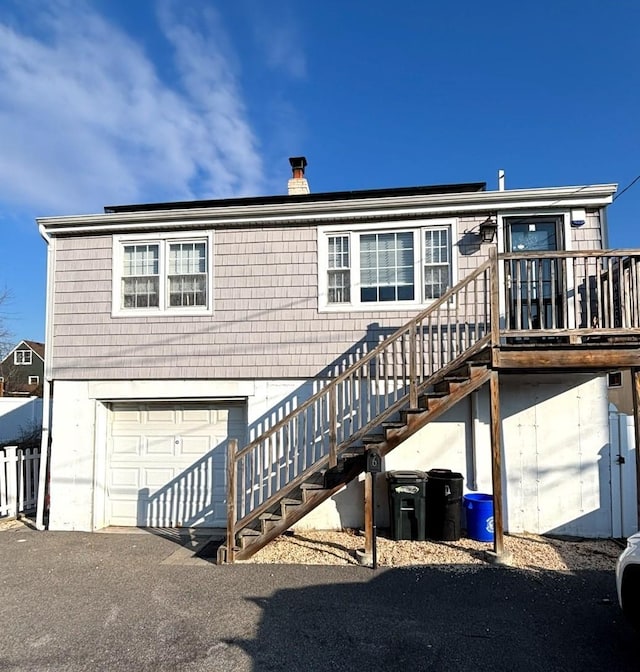 back of property with a garage