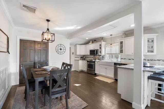 dining area featuring ornamental molding and dark hardwood / wood-style floors