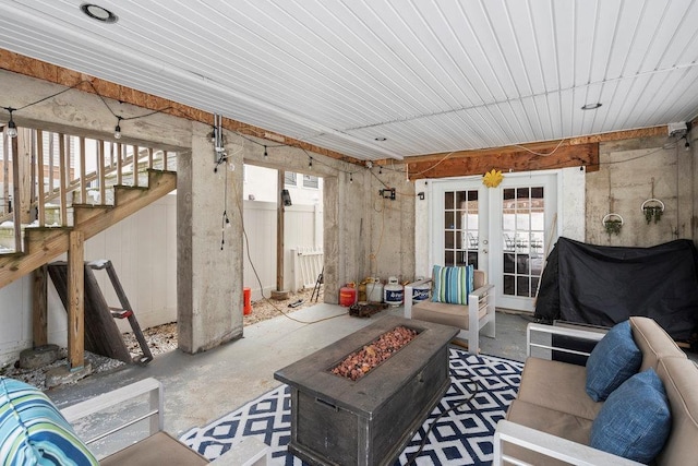 interior space featuring french doors, a healthy amount of sunlight, and concrete floors