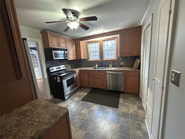 kitchen with ceiling fan, sink, appliances with stainless steel finishes, and tasteful backsplash