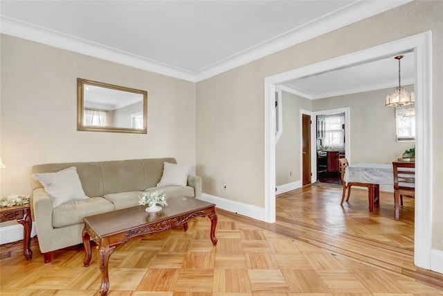 living room with ornamental molding, light parquet flooring, and a notable chandelier