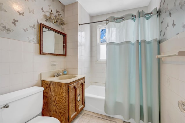 full bathroom with vanity, tile walls, shower / tub combo, and toilet