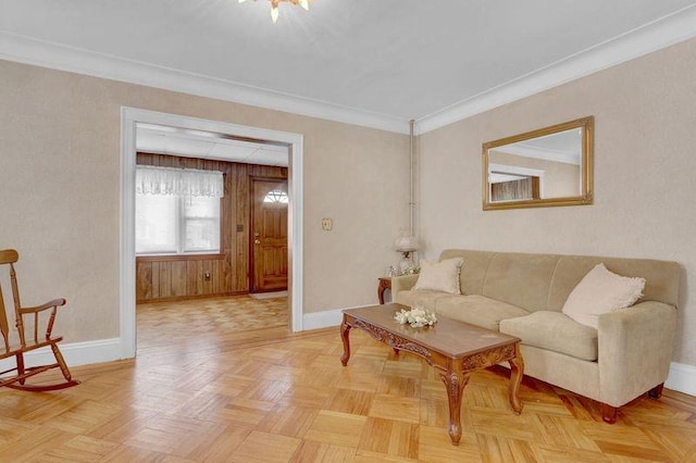 living area featuring baseboards and ornamental molding