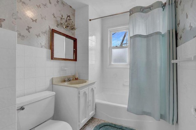 bathroom with toilet, wallpapered walls, shower / bath combination with curtain, and tile walls