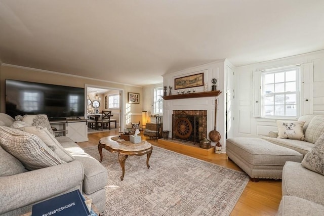 living room featuring ornamental molding and light hardwood / wood-style flooring