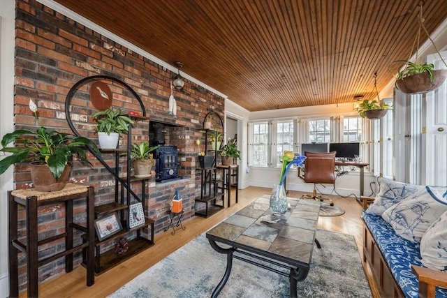 living room with wooden ceiling, brick wall, a wood stove, and light hardwood / wood-style flooring