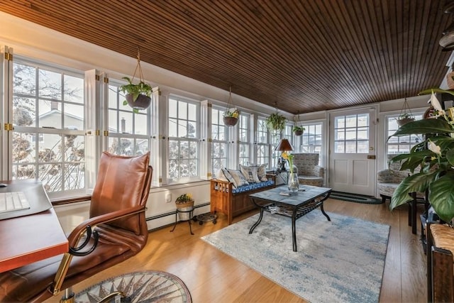 sunroom / solarium featuring a baseboard radiator and wooden ceiling